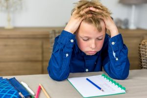 Young boy struggling with his homework