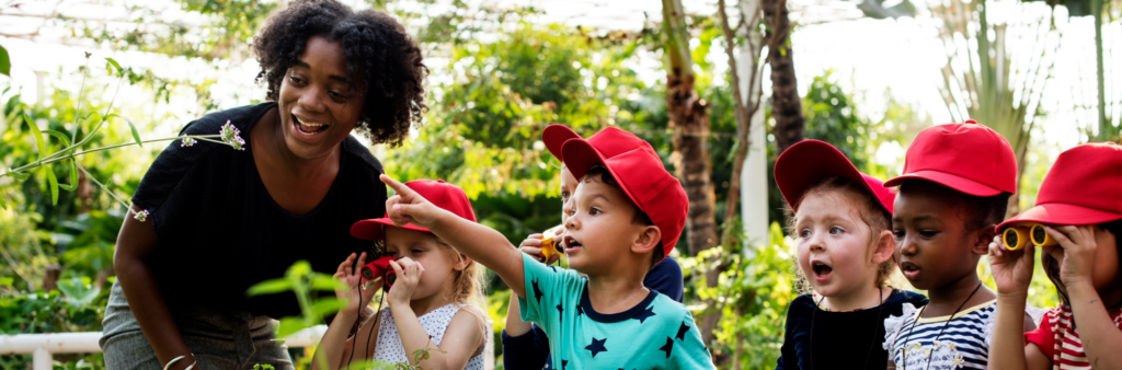 Teacher showing young students different kinds of plants. Strengthening culture through trust building.