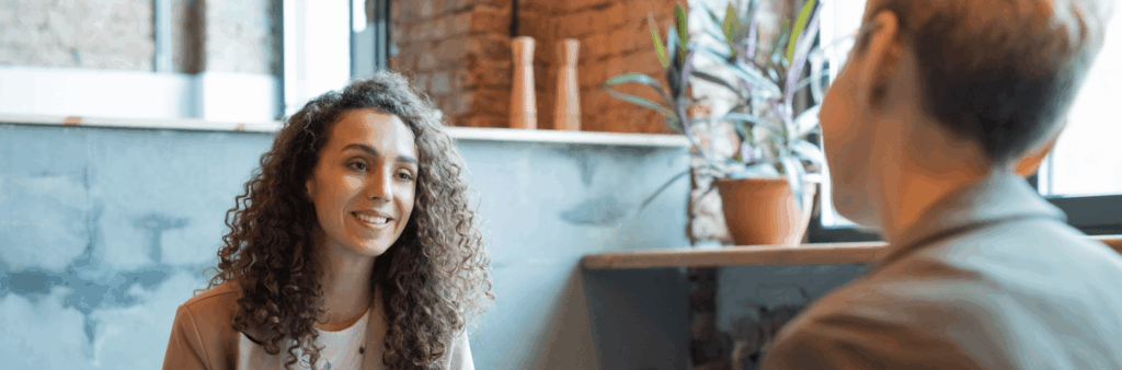 Two employees talking, one receiving constructive feedback from another