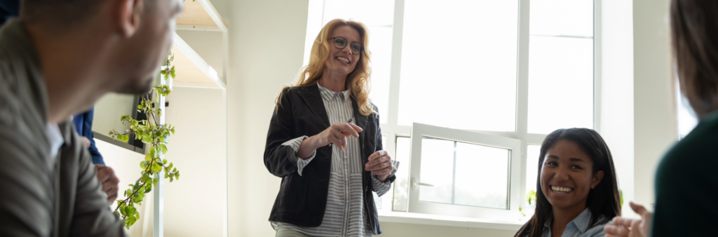 A woman speaking with her colleagues to spark and sustain change, gathering input