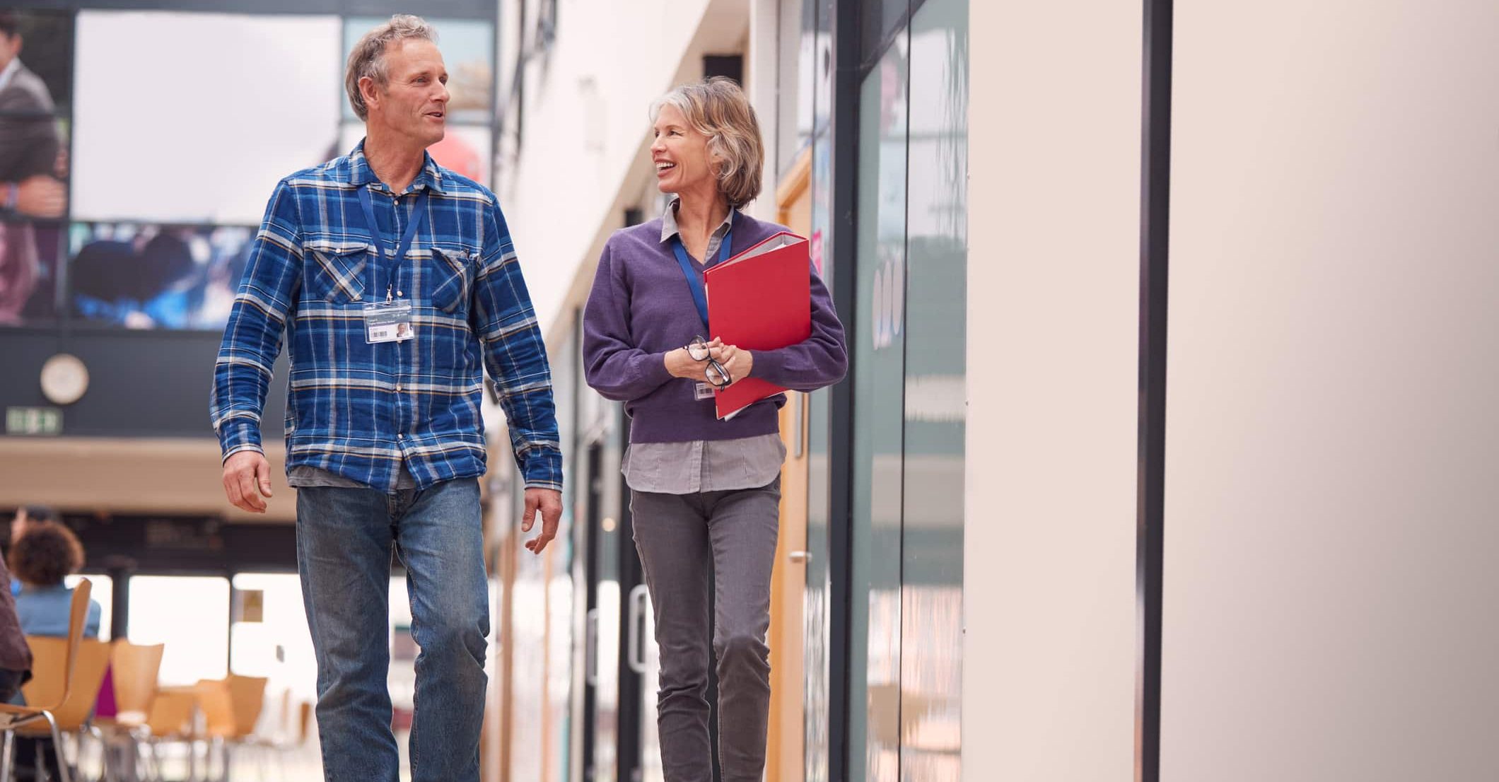 Education leaders walking through school building in connection