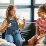 Improving School Culture Through Student Voice and Engagement - Elementary students in group sharing their thoughts and perspectives