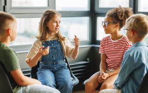Improving School Culture Through Student Voice and Engagement - Elementary students in group sharing their thoughts and perspectives